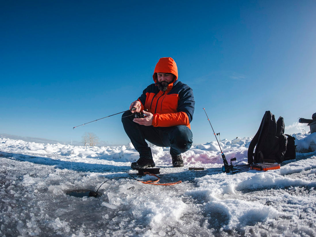 Ice fishing through a hole in a frozen Arctic lake